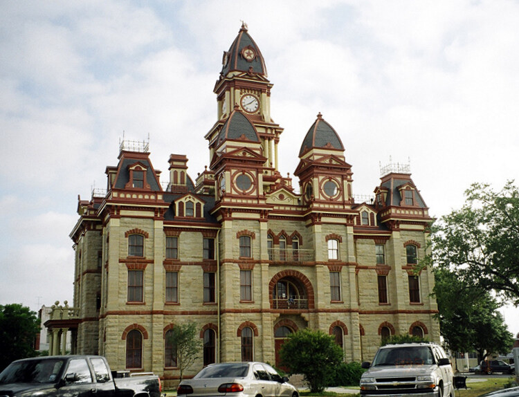 Historic Texas courthouse centered on a traditional town square at golden hour